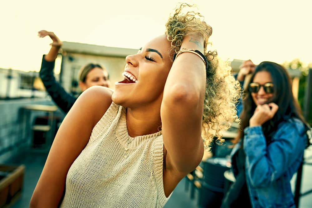 Lady dancing with friends